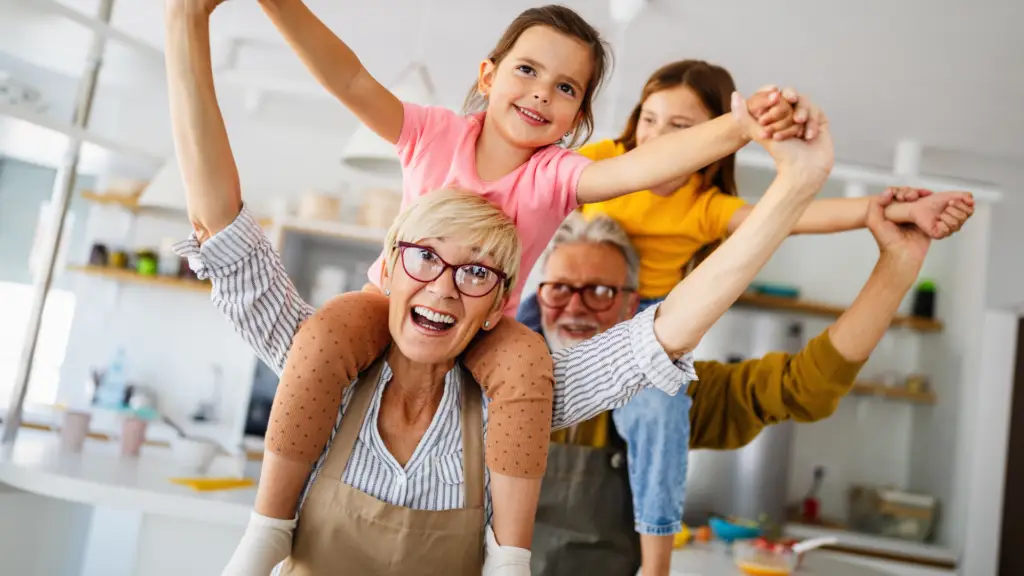 grandparents happily playing with their grandchildren