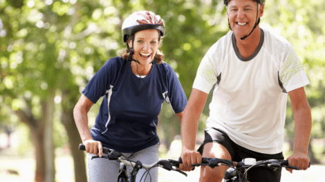 retired couple happily biking