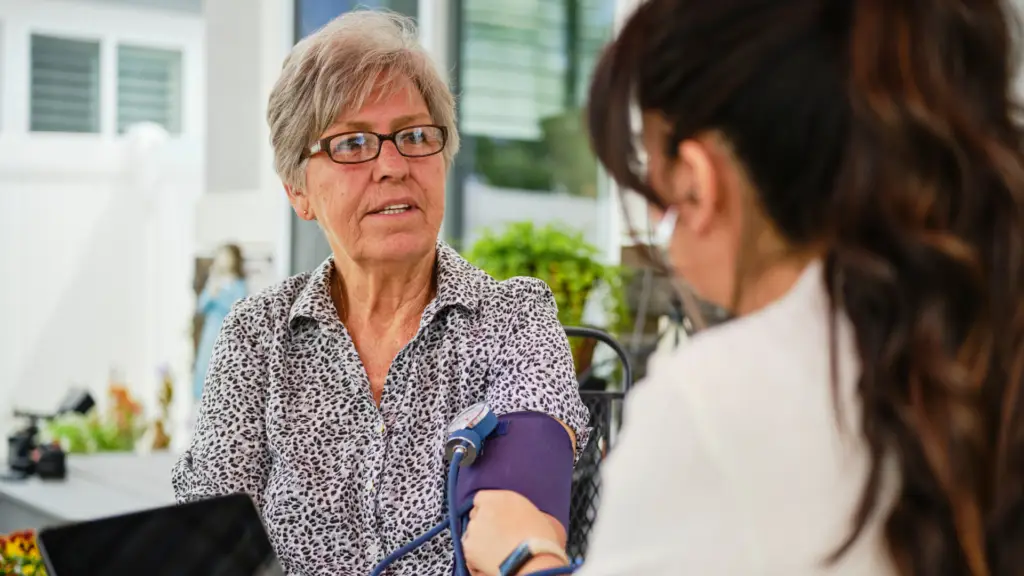 doctor taking blood pressure of medicare patient