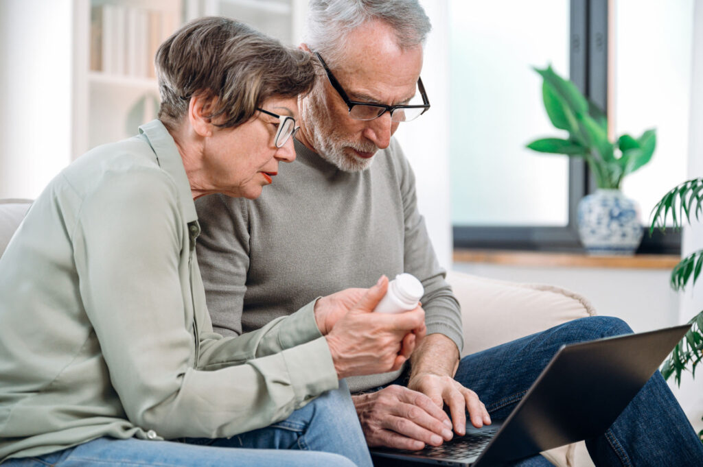 Elderly couple reviewing medication coverage