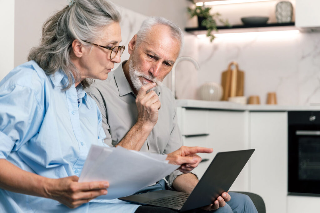 Senior couple comparing Medicare Part D prescription drug plans and Medicare Advantage coverage options