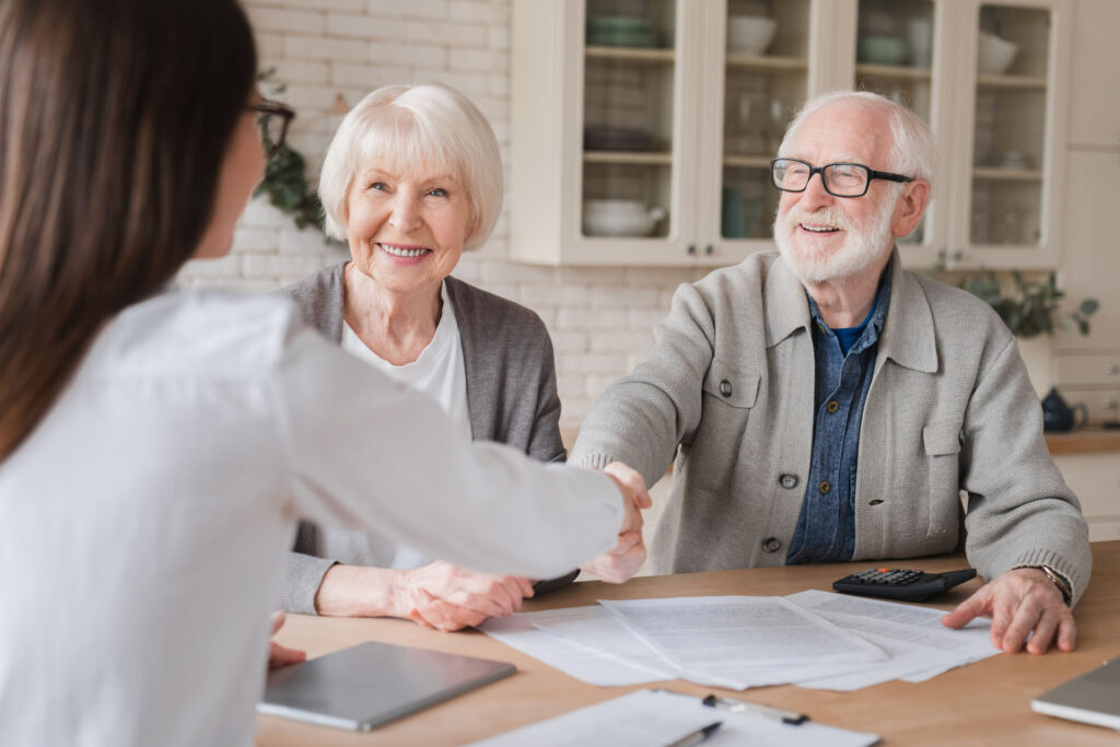 Senior couple meeting with a Medicare insurance agent to review plan options and enrollment information