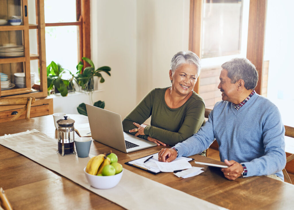 Senior couple reviewing Medicare enrollment paperwork and healthcare coverage options in Michigan