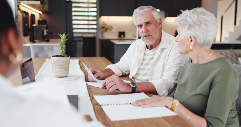 Senior couple discussing Medicare coverage options with an independent insurance agent