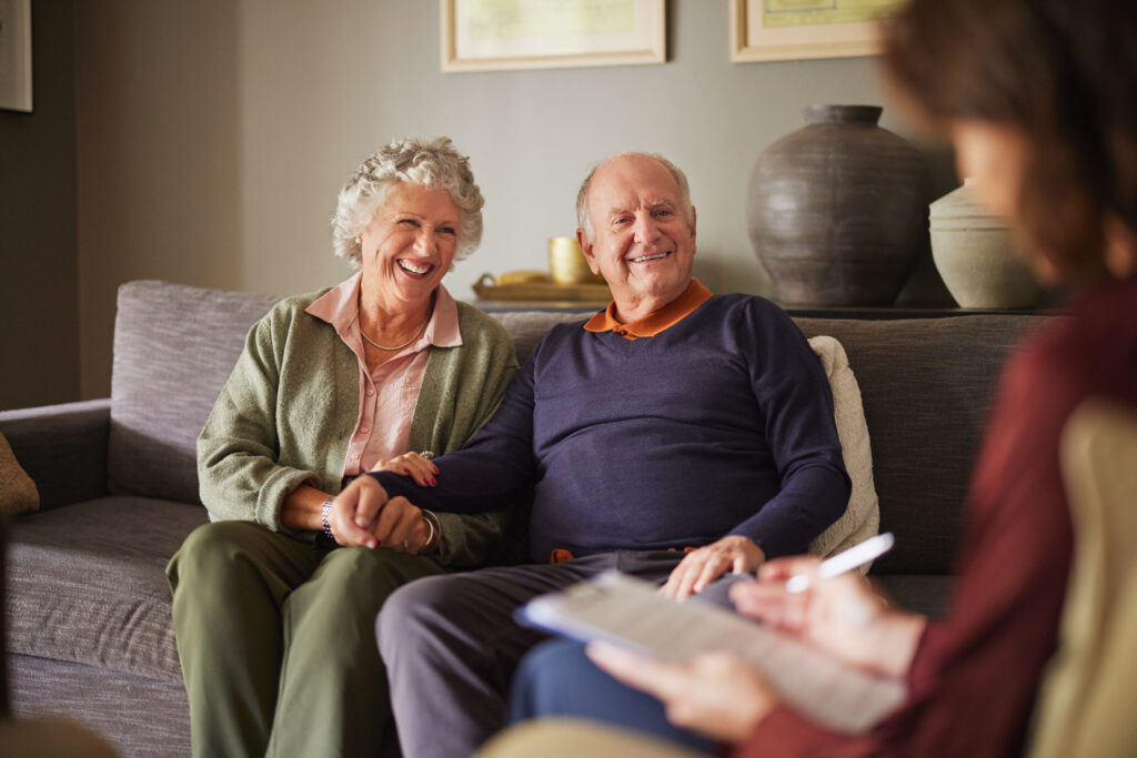 Senior couple speaking with a licensed Medicare agent about healthcare coverage options in Michigan