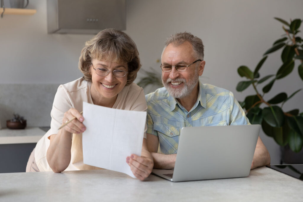 Senior couple reviewing Medicare Supplement plan paperwork and coverage options in Michigan