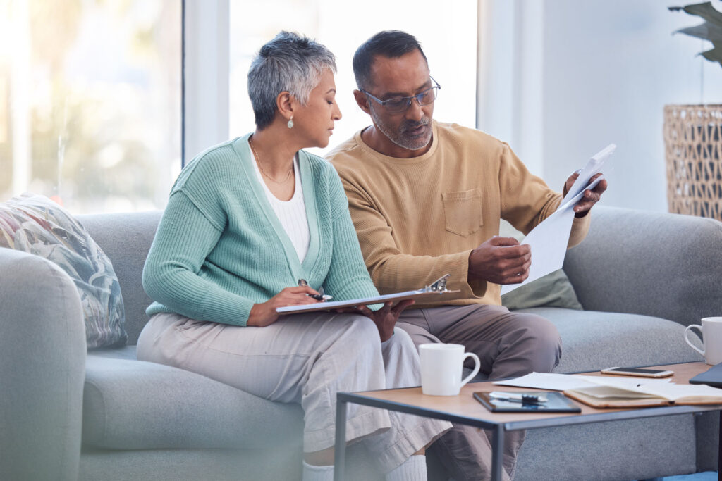 Does Medicare Cover Auto Accident Injuries in Michigan? Senior couple reviewing Medicare and no-fault insurance coverage documents in Michigan