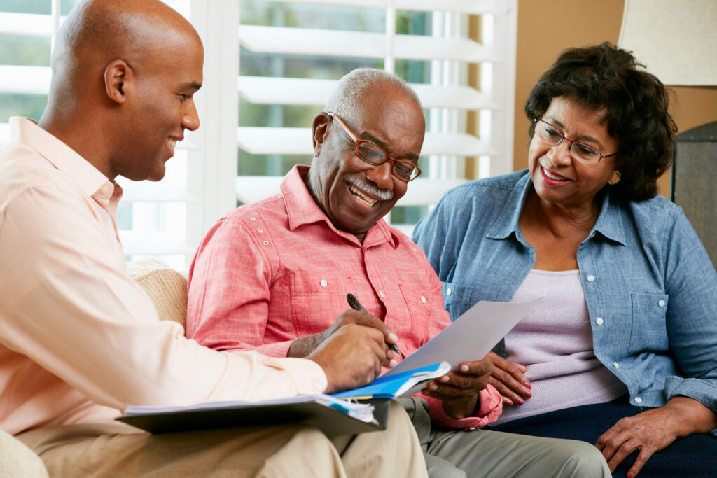 Senior couple discussing Michigan Medicare health plan options with a healthcare professional.